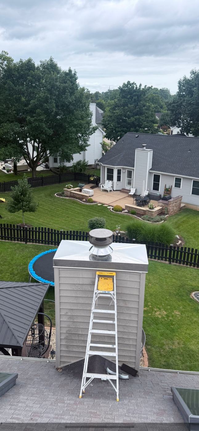 New stainless chimney chase cover with the skirt running down over the siding so water never reaches the framing