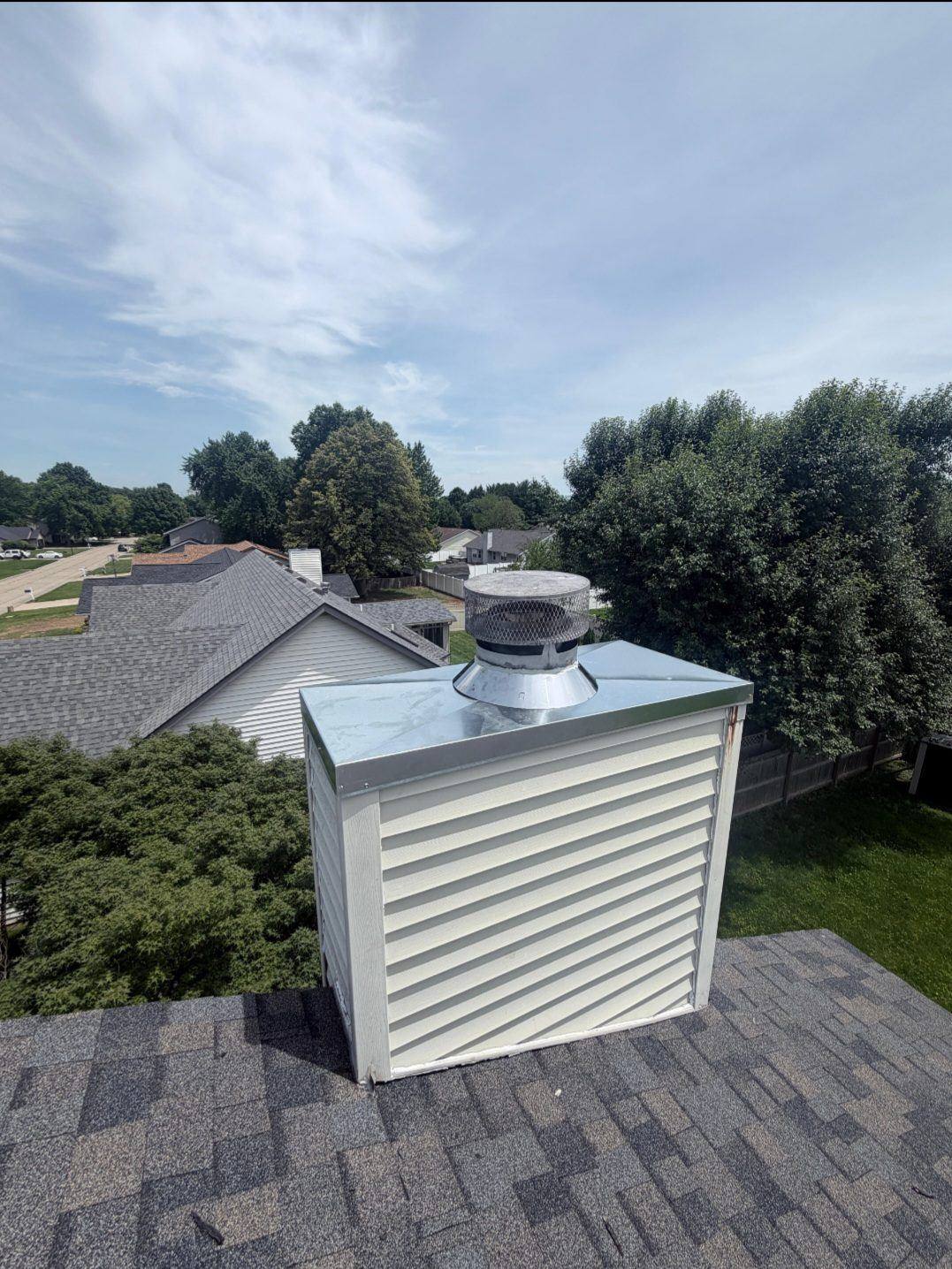 Rusted galvanized chase cover on a chimney chase in Swansea IL