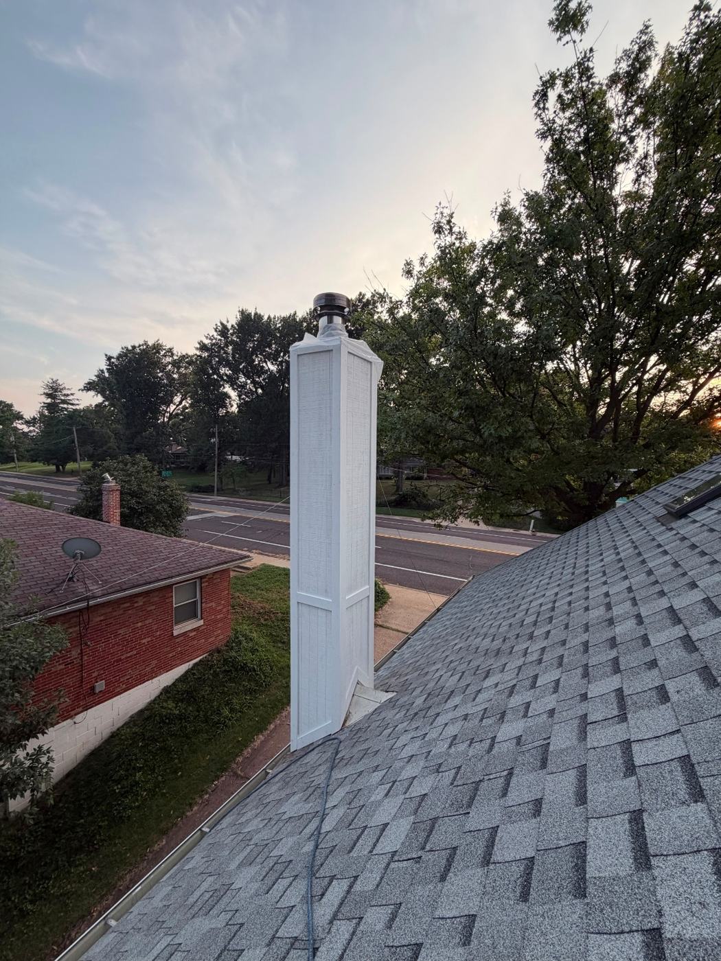New siding going onto the chimney chase with corner trim run tight so nothing is left open at the edges