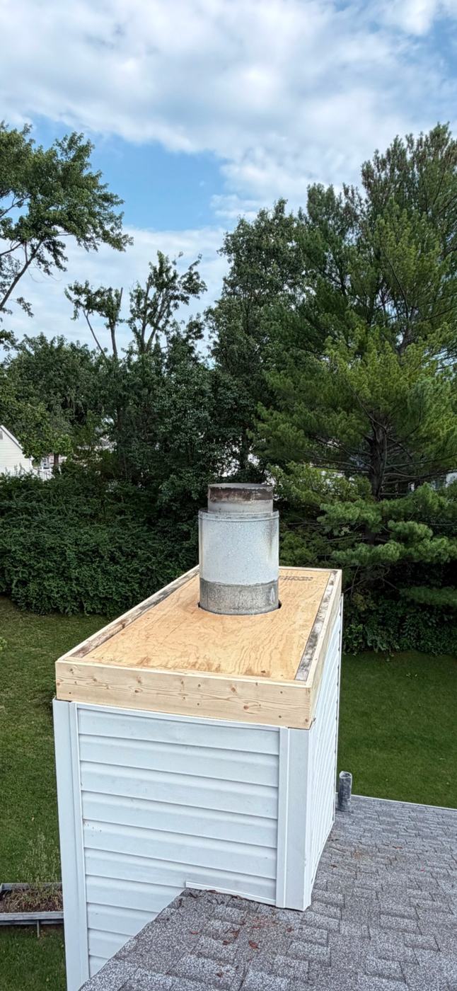 Chimney chase top rebuilt with a new plywood deck and new perimeter framing, square and dry, ready for a new cover