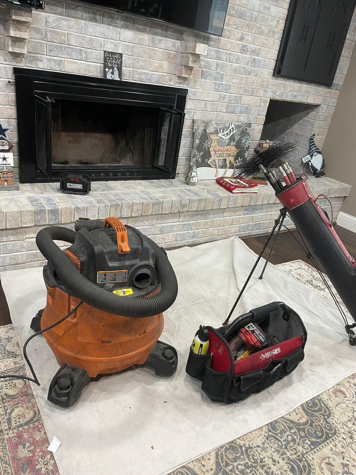 Chimney sweep setup — HEPA vacuum and brush equipment ready