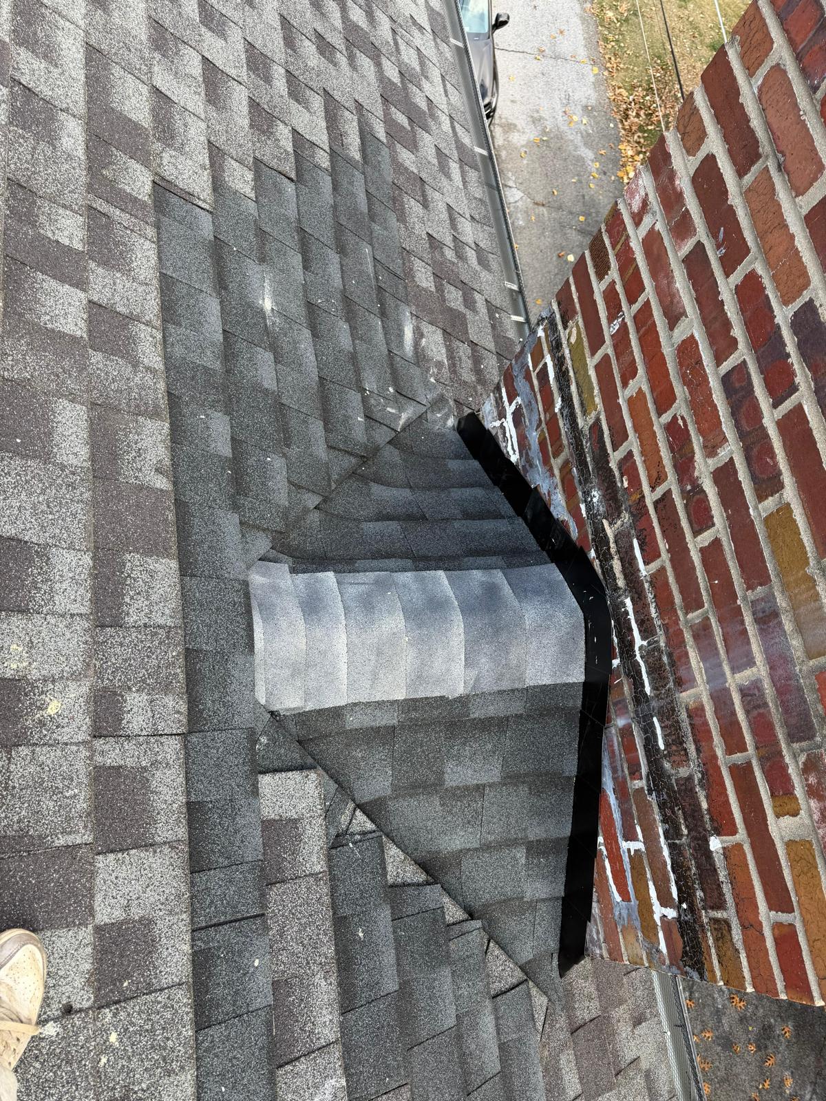 Completed chimney cricket shingled and sealed — water diverted