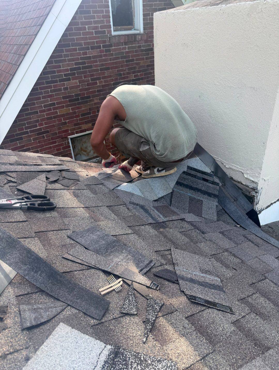 Shingling and flashing a new chimney cricket in South St. Louis