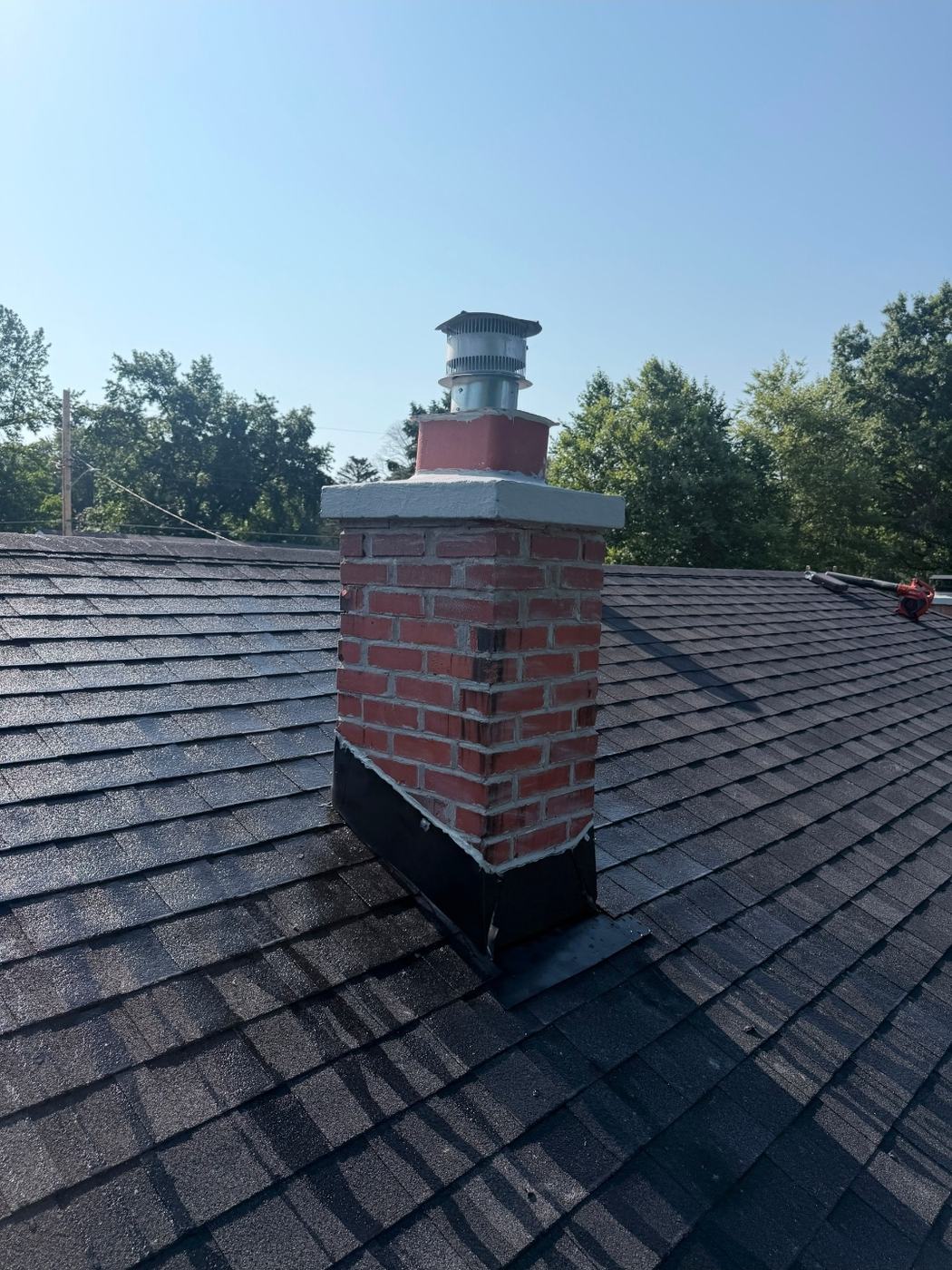Masonry chimney with a rebuilt crown and a new stainless rain cap sized to the flue, St. Louis MO