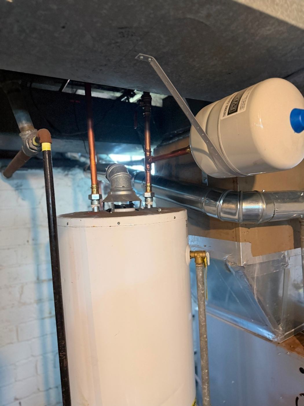 Water heater and furnace connections in the basement tied into one properly sized stainless chimney liner, St. Louis MO