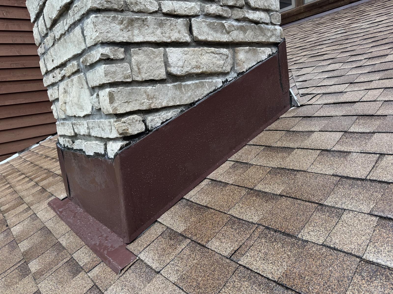 New chimney flashing installed and sealed after repair