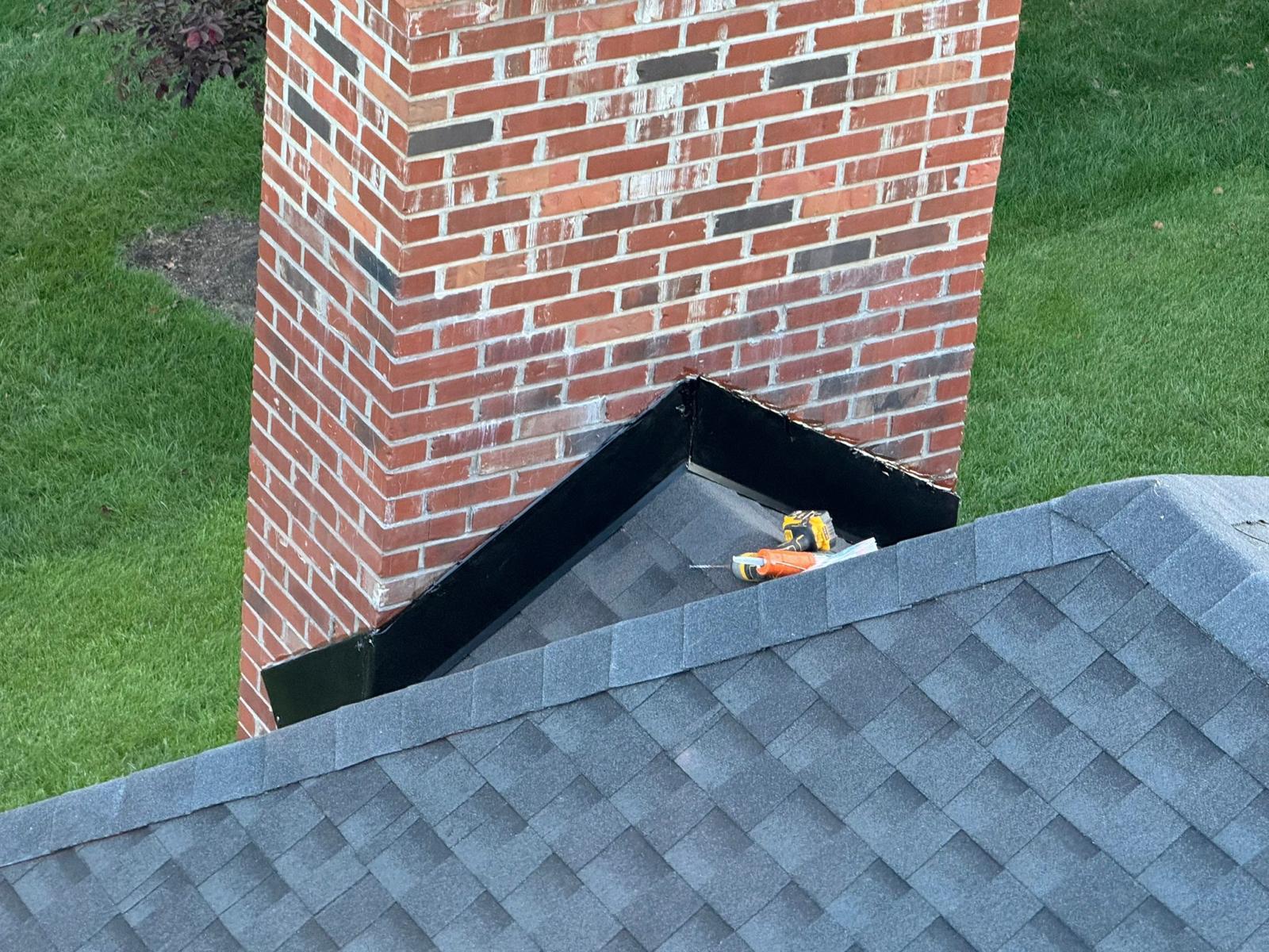 Chimney flashing installation step 1 — base flashing