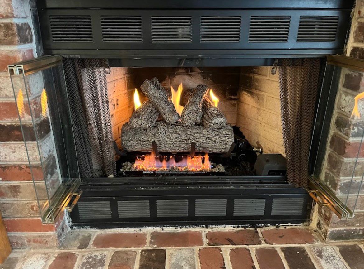 Gas fireplace with logs burning — after service