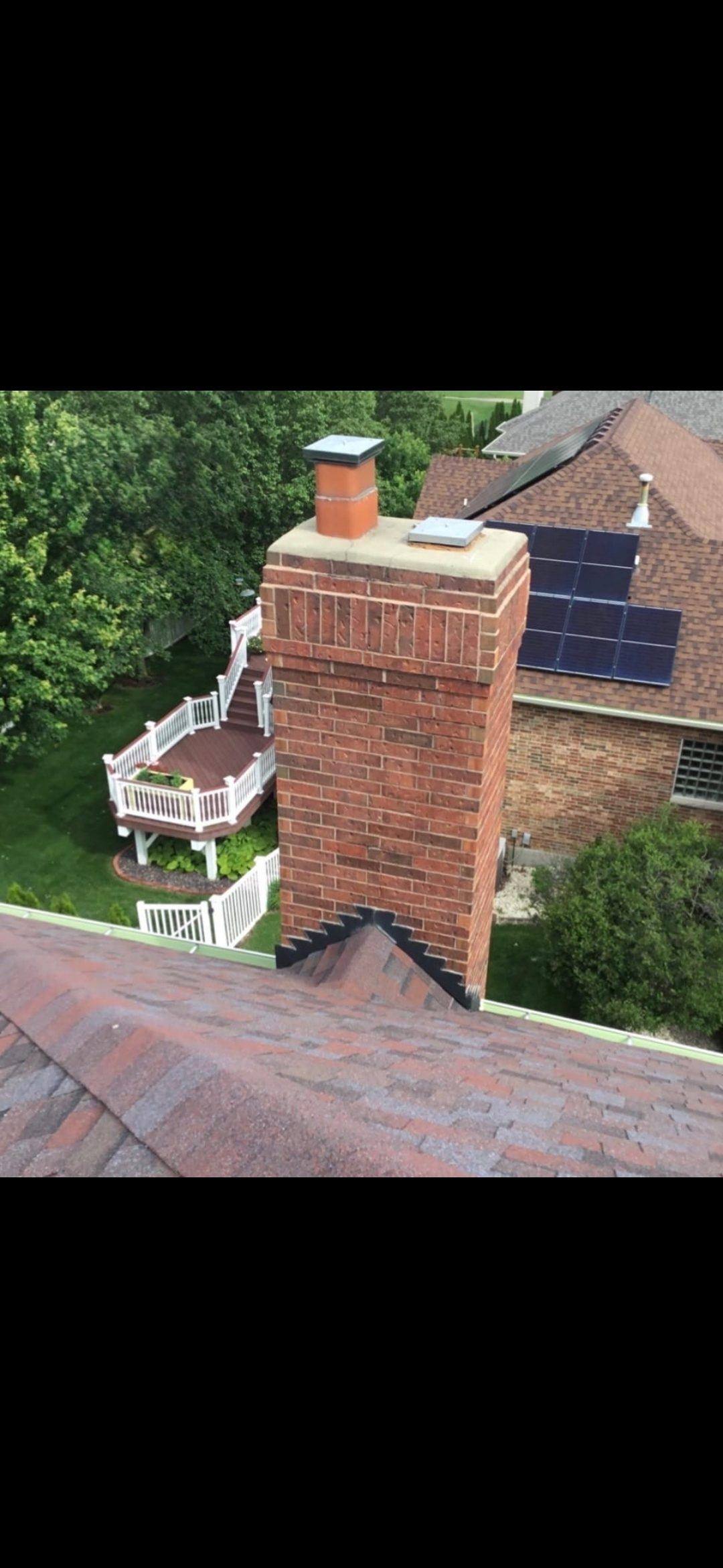 Wentzville brick chimney before repair — right flue tile flush with crown, water entry risk