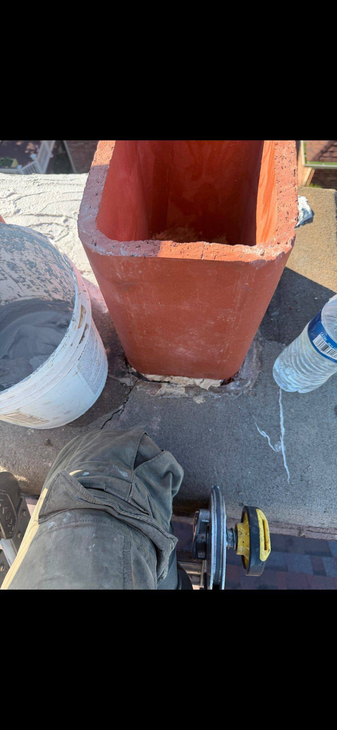 New clay flue extender installed on right flue with fresh mortar seal