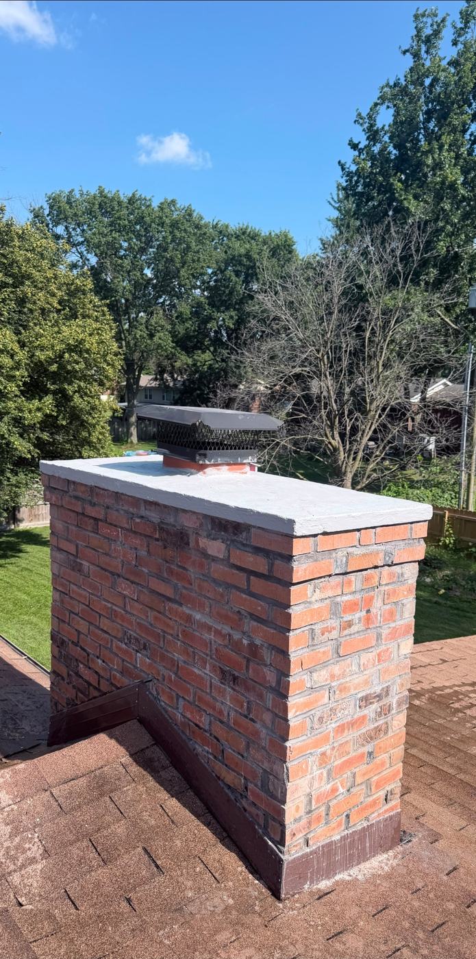 Chimney rebuilt above the roofline with a new poured crown, reset flashing and counterflashing, St. Louis MO
