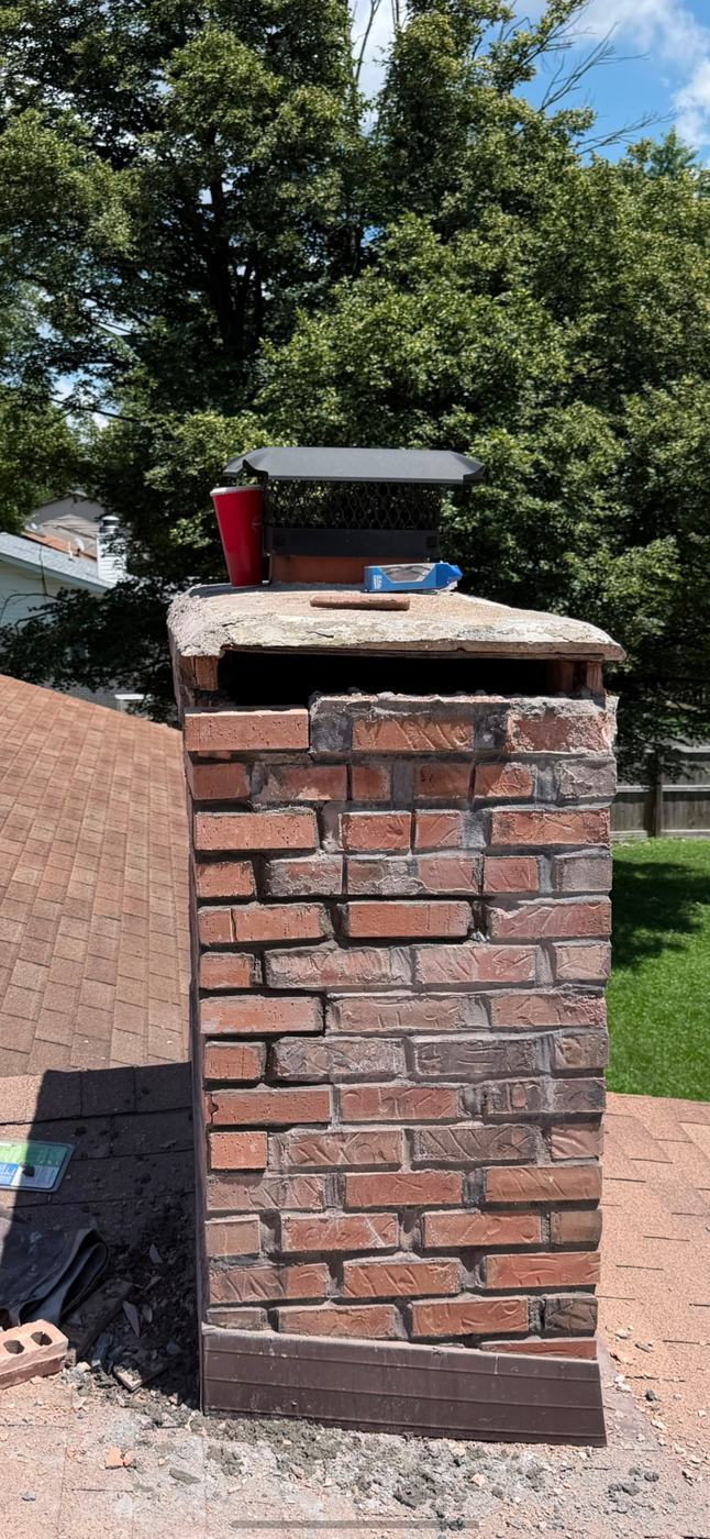 Bad brick removed and new brick going back in course by course on the chimney corner, St. Louis MO