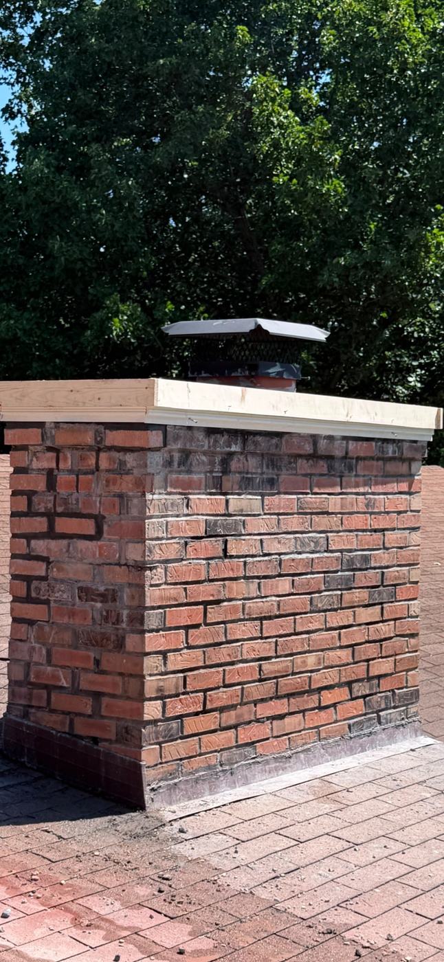 Rebuilt and tooled chimney brickwork with a wood form set for a poured crown that overhangs the brick face