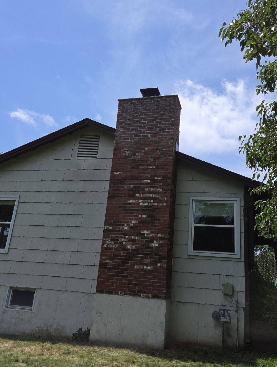 Full chimney height from ground level — showing original character preserved with new stable top