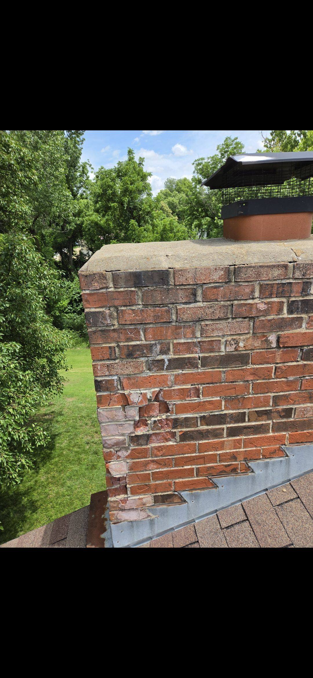 Metal patch plate bolted over a chimney crack
