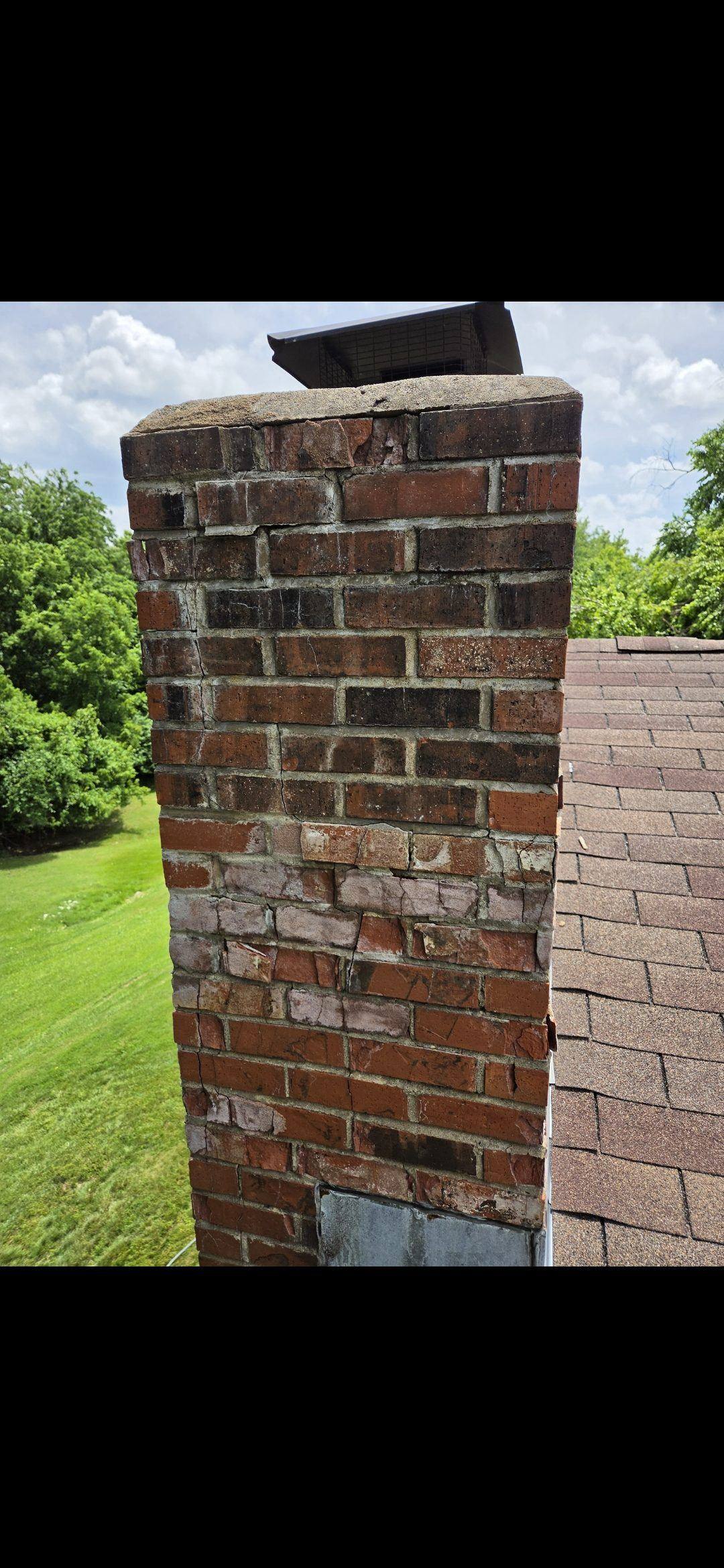 Loose top courses of brick on a cracked chimney