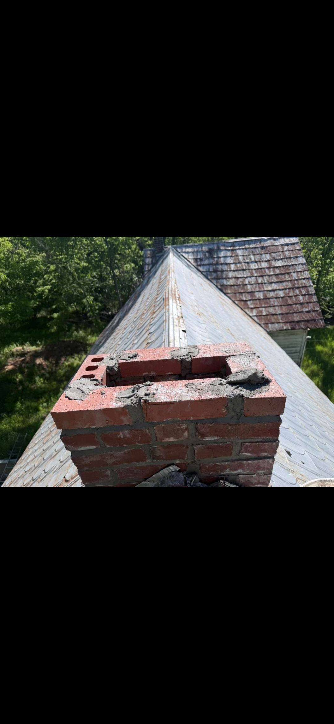 Above-roofline chimney rebuild in progress