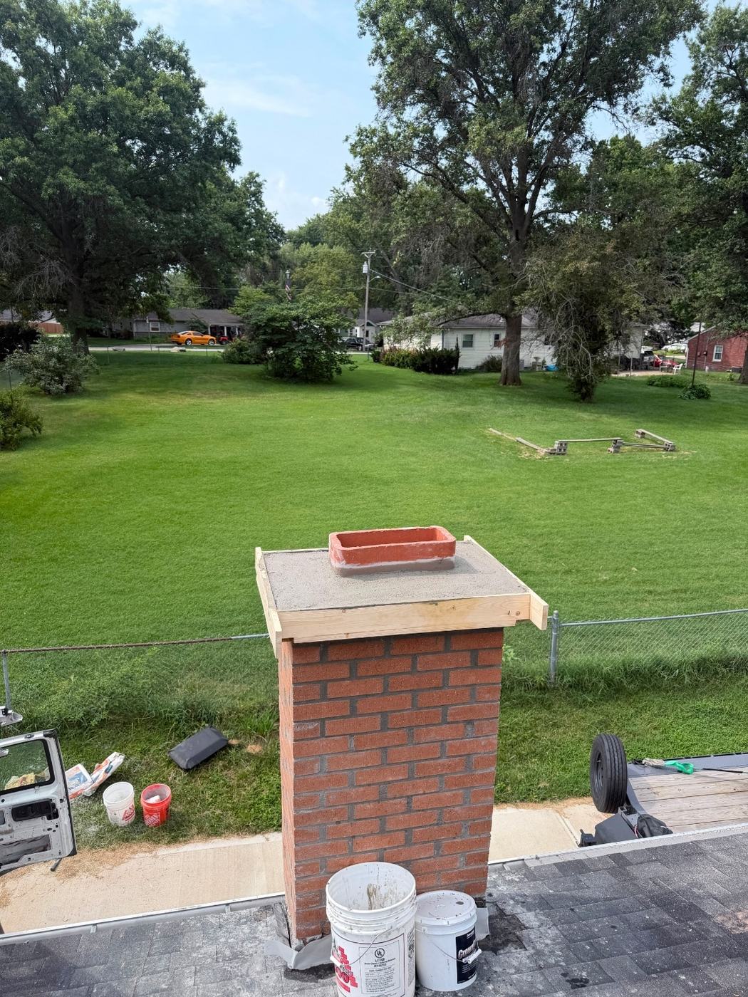 Chimney crown built on a wood form that runs past the brick on every side to give the finished crown a real overhang