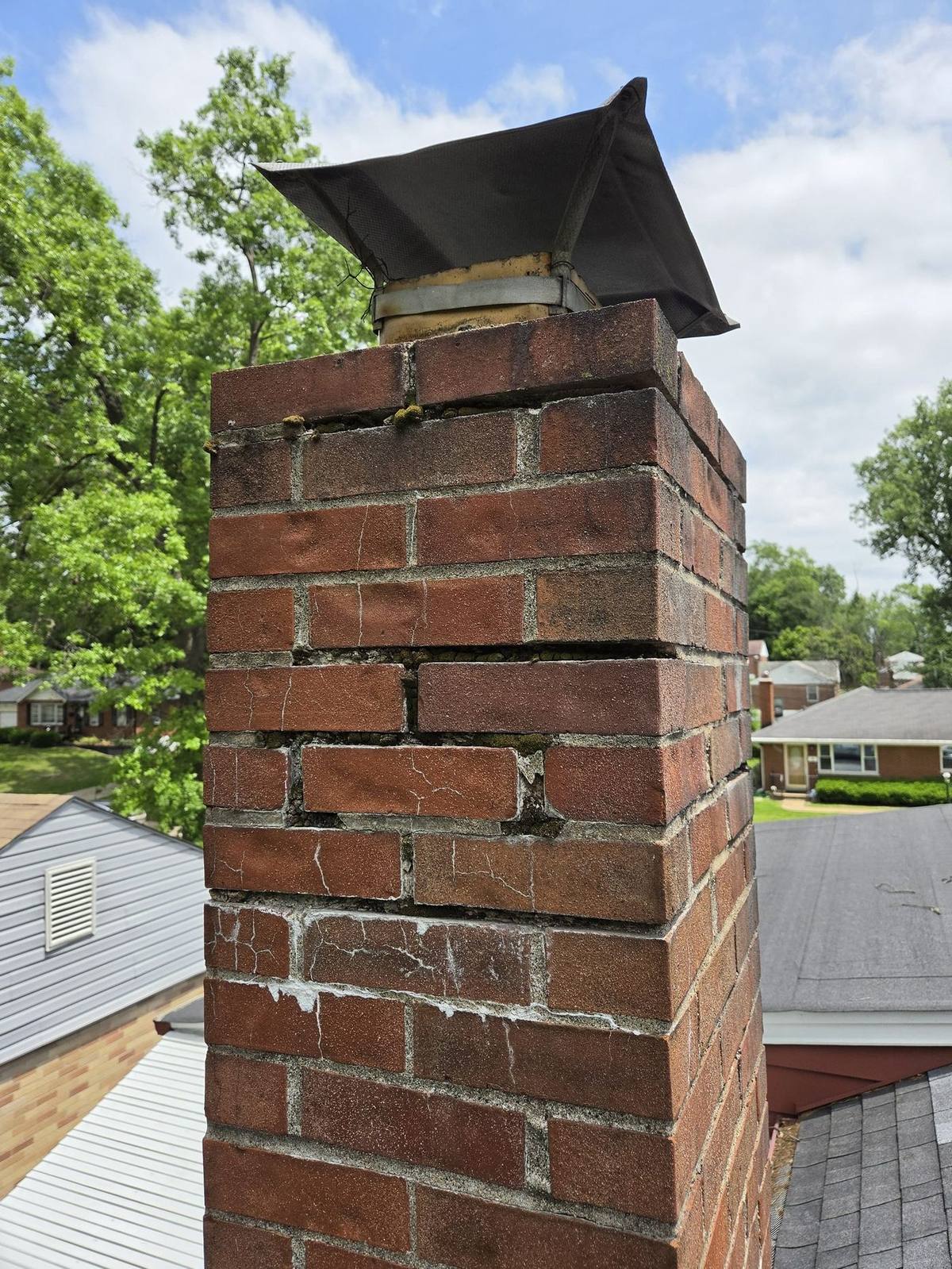 University City brick chimney with failed mortar joints before tuckpointing