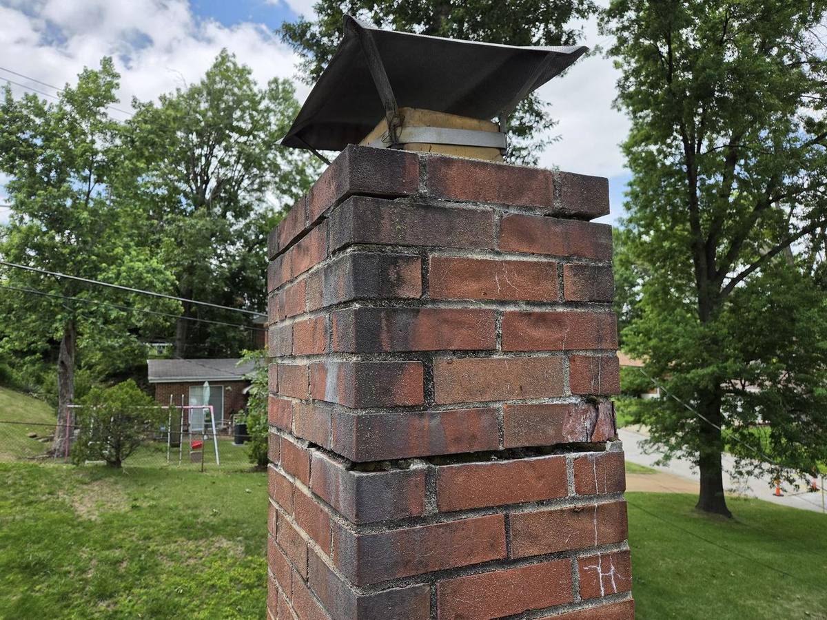 Deteriorated mortar joints on opposite side of chimney before tuckpointing