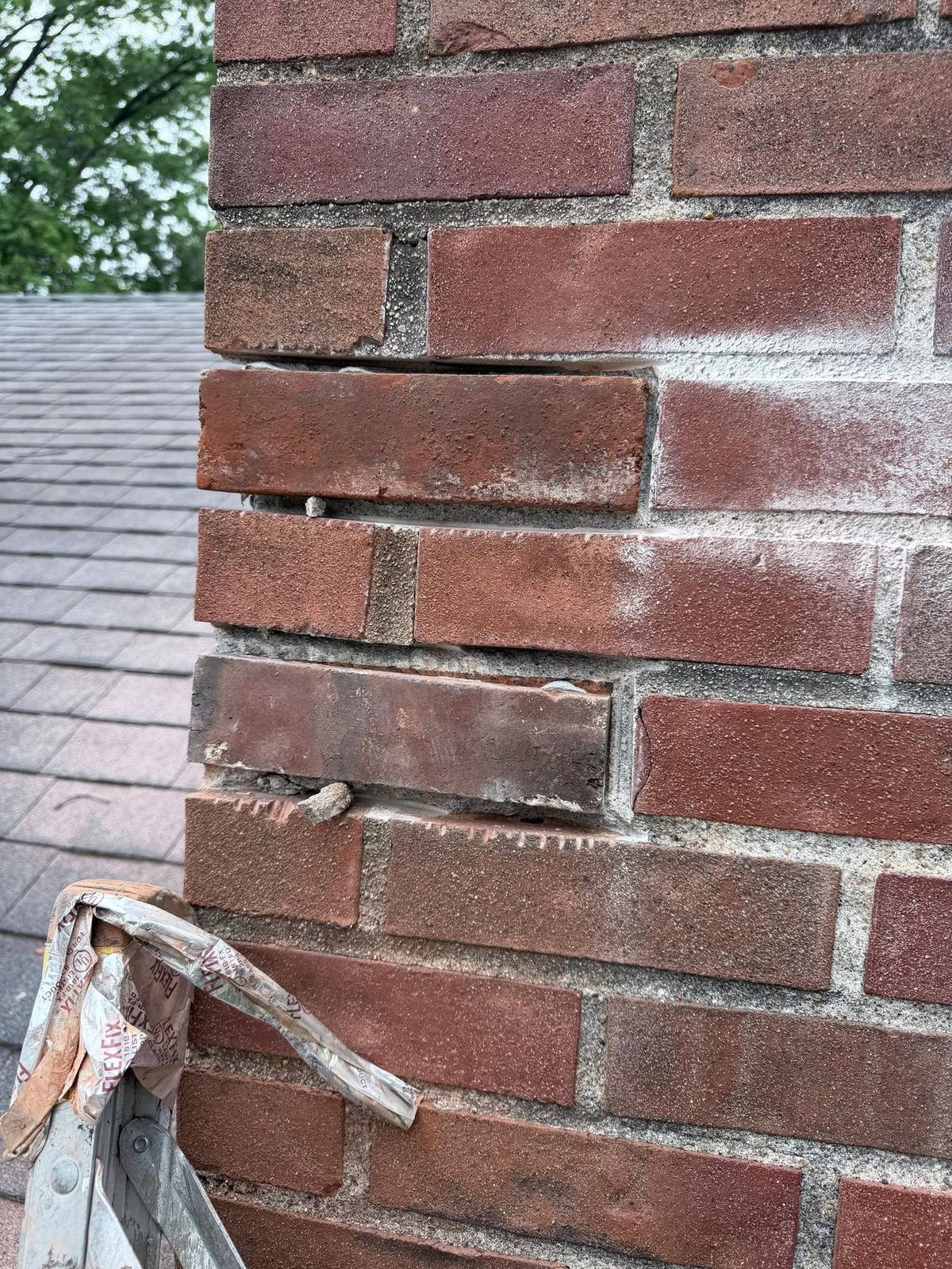 Grinding out failed mortar joints to full depth on a University City chimney
